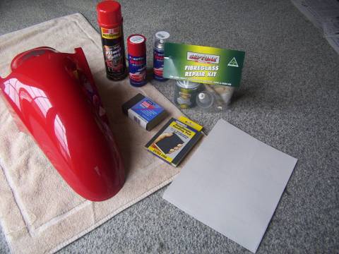 All the essentials to fixing cracked fairing with fibreglass. In hindsight i'd have some plastex in there to fix the crack, but i'd still reinforce it with glass.