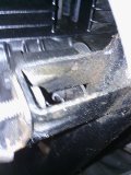 this bracket is located about where the middle ferrin joins the belly pan, it is a standard fixture to the main frame