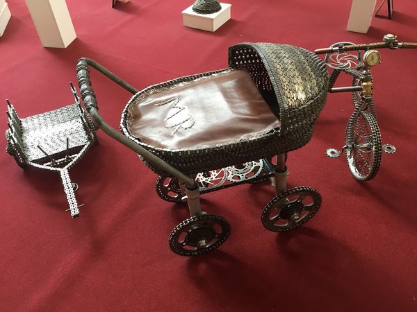 They love doing shit with motorbicycle bits. Pram made of chains and sprockets.