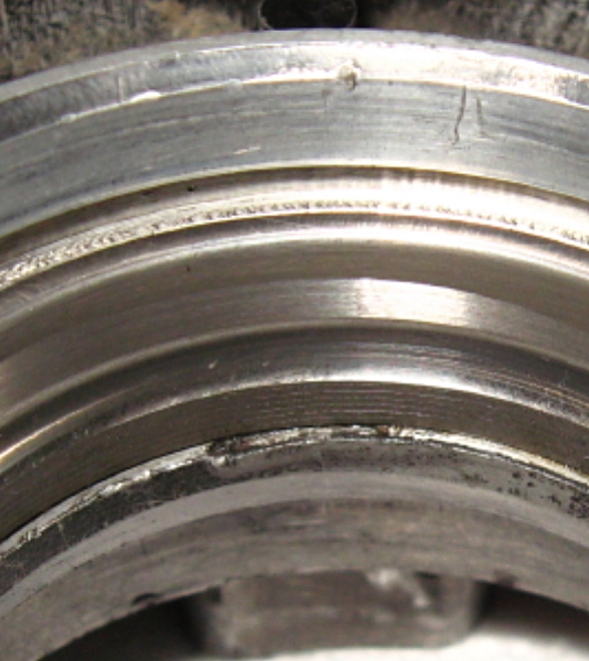 Somebody has had a go at this in the past. I suspect there was no success and the worn bearing inner ring and cage was whacked back together.