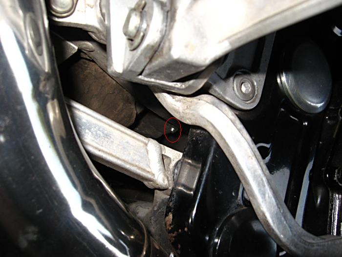 In this dark and dirty recess lies the hidden grease nipple for the swingarm.