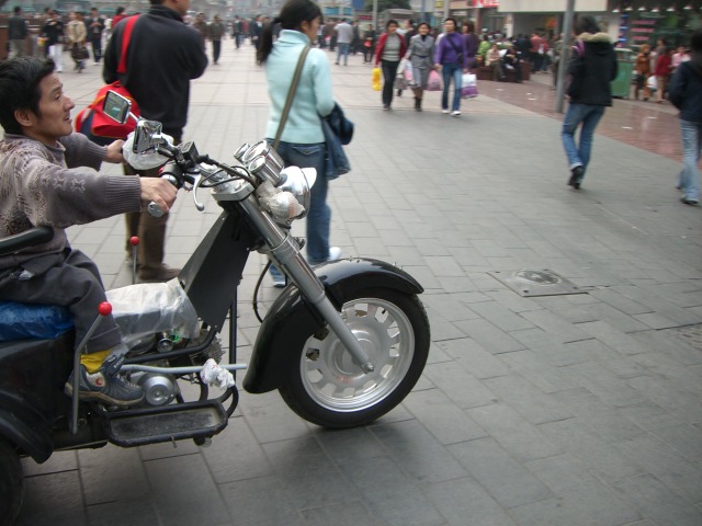 check out the pegs, he's modified them for his umm... ahh stuff political correctness, he's a midget on a trike.