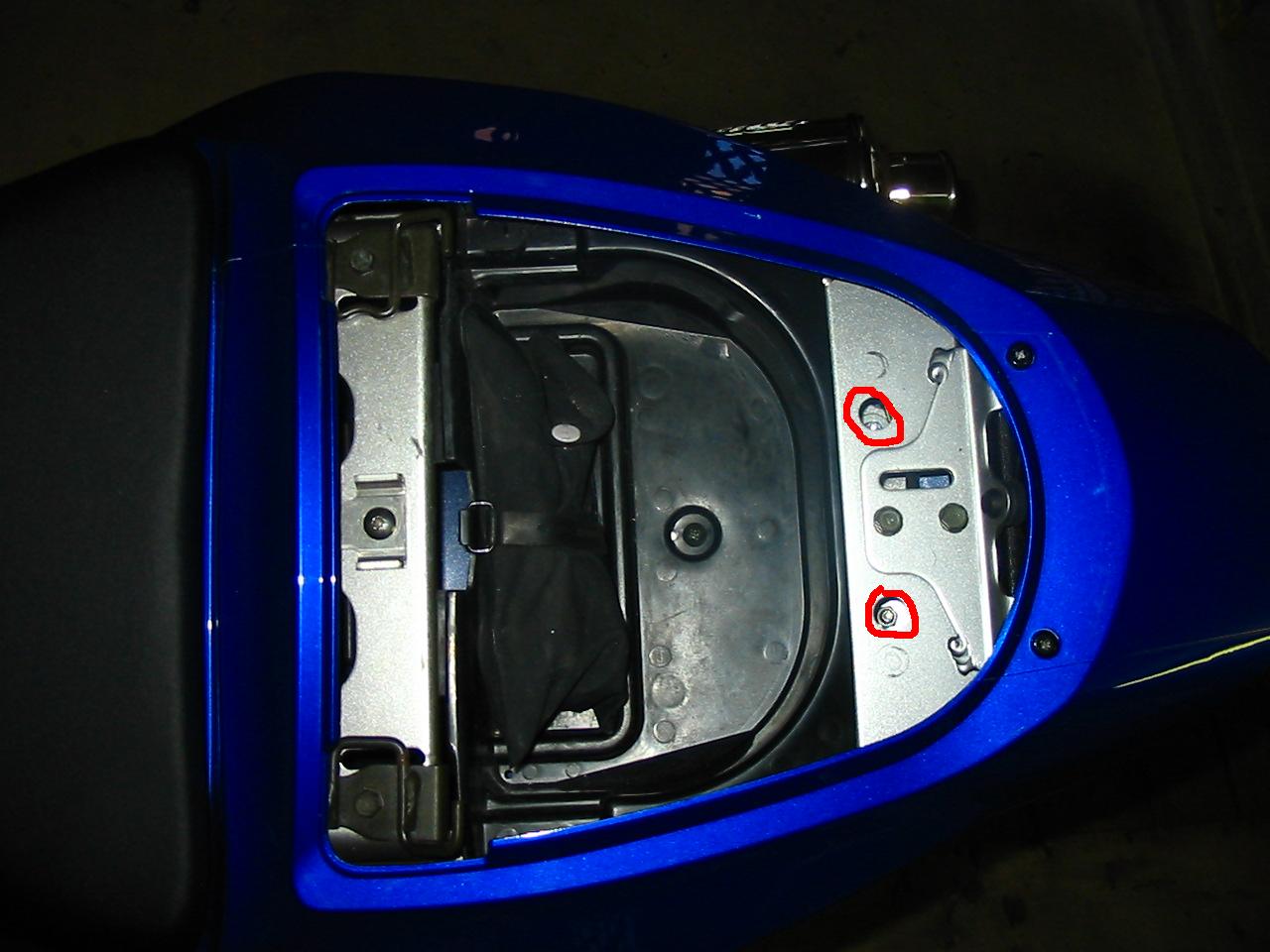 top view: need to get rid of the storage comparment to get to the bolts - how?
